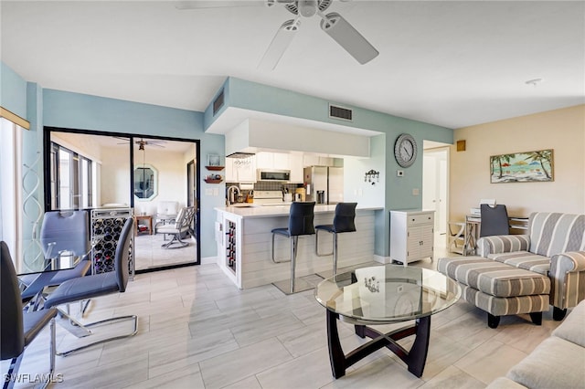 living room with ceiling fan and sink