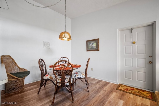 dining space featuring wood-type flooring