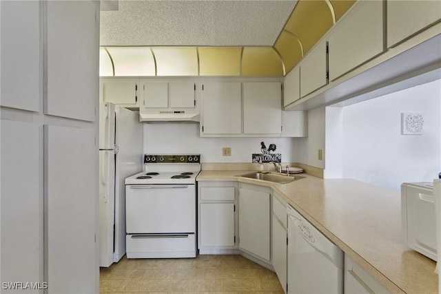 kitchen featuring sink and white appliances