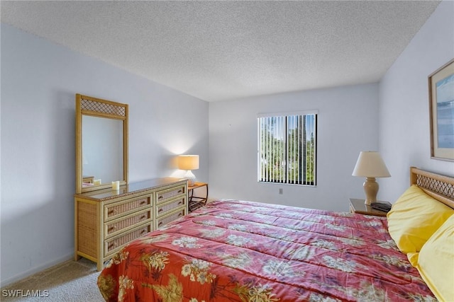 bedroom featuring carpet and a textured ceiling