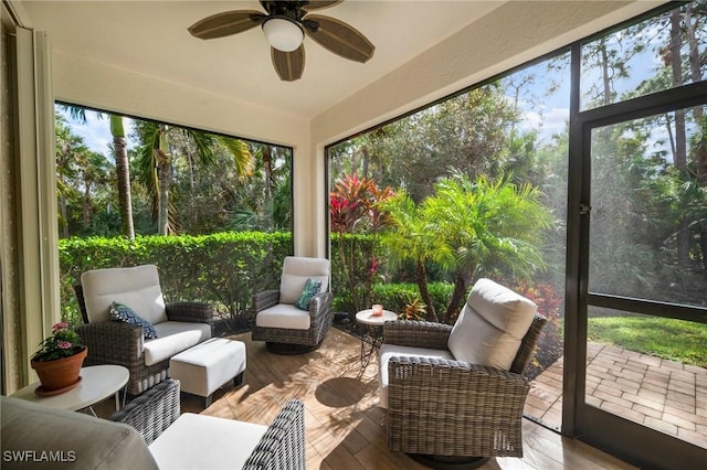 sunroom / solarium featuring ceiling fan