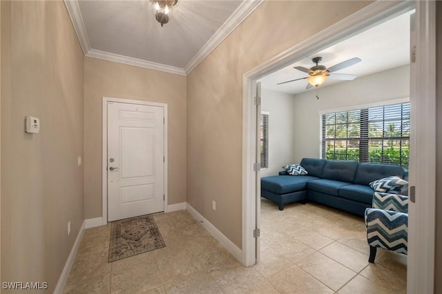 entrance foyer featuring ornamental molding, ceiling fan, and light tile patterned floors