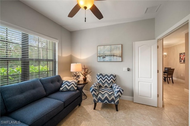 tiled living room featuring ceiling fan