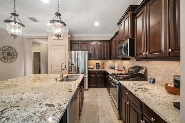 kitchen featuring appliances with stainless steel finishes, pendant lighting, dark brown cabinets, and an inviting chandelier