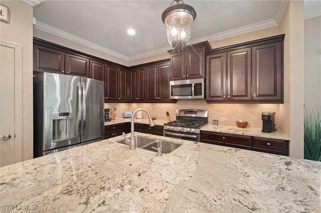 kitchen with hanging light fixtures, dark brown cabinetry, crown molding, appliances with stainless steel finishes, and sink