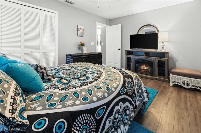 bedroom with wood-type flooring and a closet