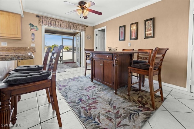 kitchen with light tile patterned floors, ornamental molding, and ceiling fan