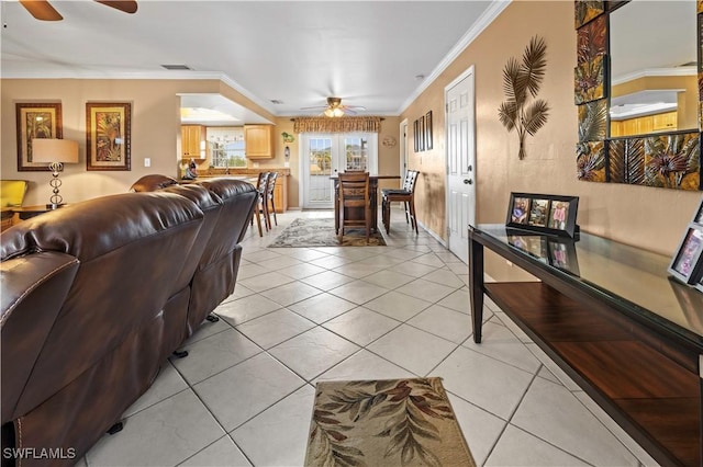 tiled living room with crown molding and ceiling fan