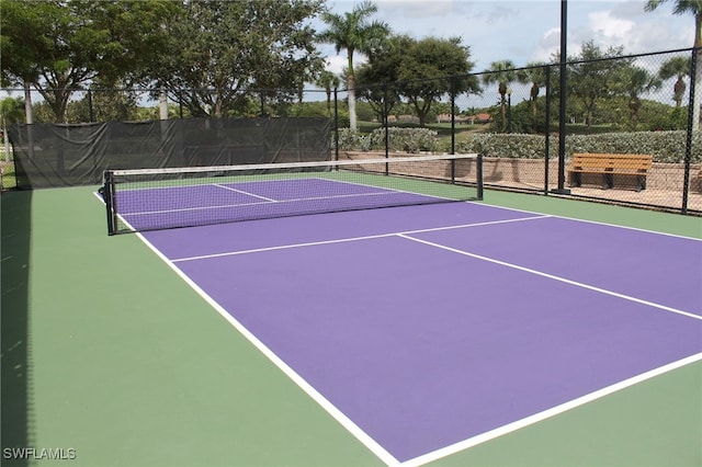 view of tennis court featuring basketball hoop