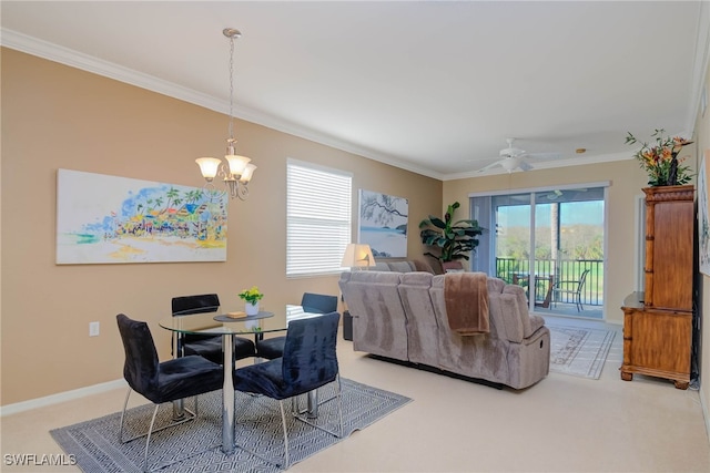 dining room with carpet flooring, ceiling fan with notable chandelier, and ornamental molding