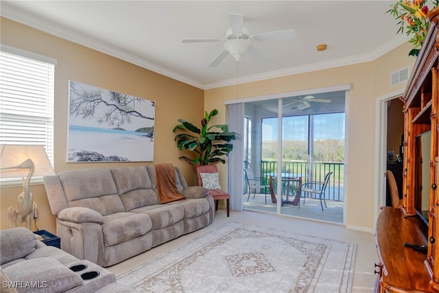 living room with ceiling fan, ornamental molding, and a wealth of natural light