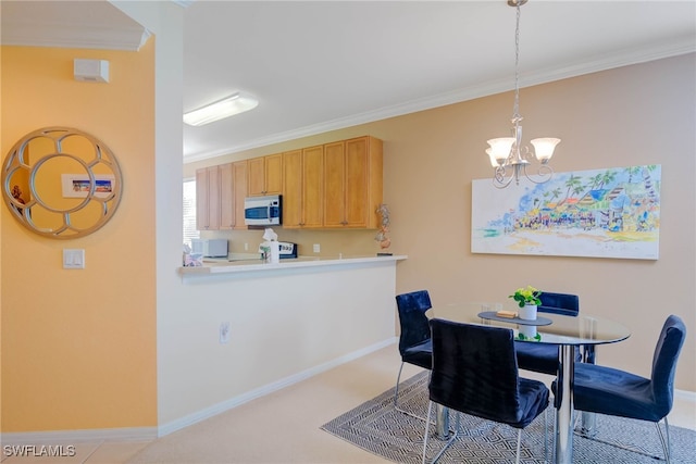 dining space featuring ornamental molding and a notable chandelier