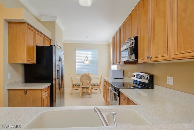 kitchen featuring appliances with stainless steel finishes, pendant lighting, crown molding, and sink