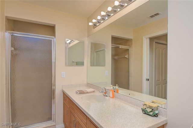 bathroom featuring vanity and an enclosed shower