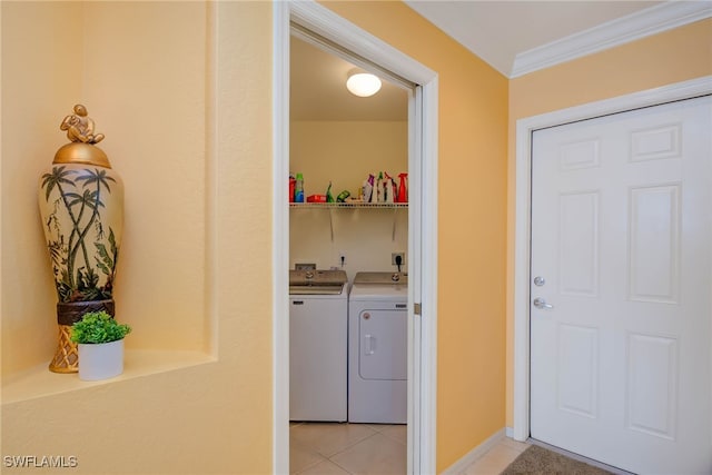 washroom with washer and clothes dryer, light tile patterned floors, and crown molding