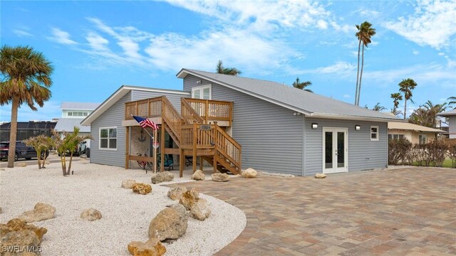 rear view of property with french doors and a deck