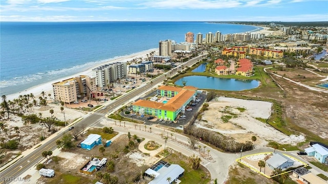 bird's eye view featuring a water view and a beach view