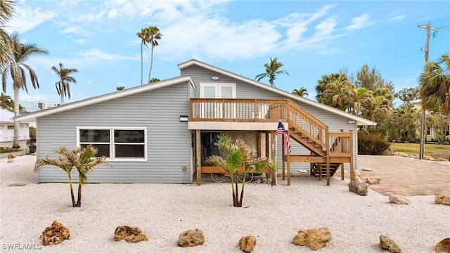 back of property with stairway and a wooden deck