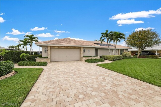 view of front of property with a garage and a front lawn