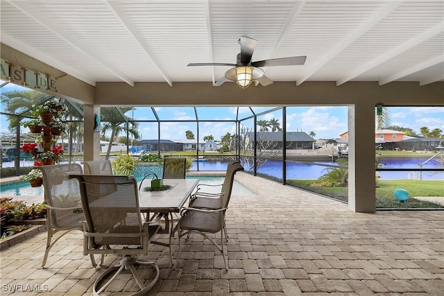 sunroom / solarium featuring plenty of natural light, beamed ceiling, and a water view