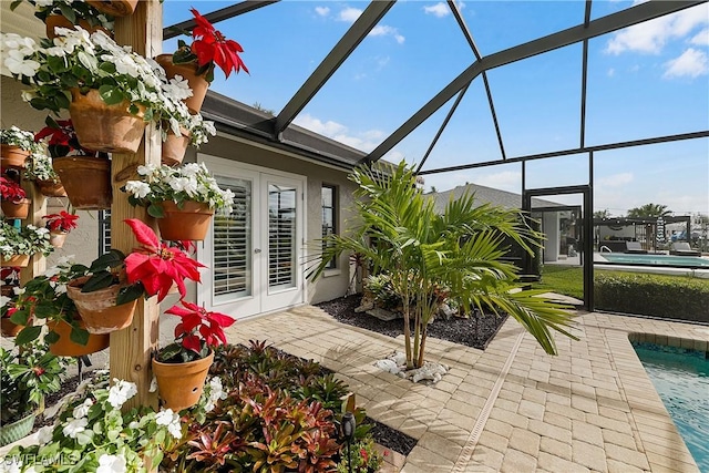 sunroom / solarium featuring french doors