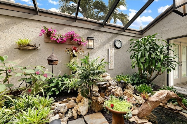 exterior details featuring a skylight and stucco siding