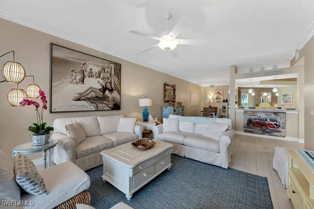 living room featuring ceiling fan, crown molding, and dark wood-type flooring