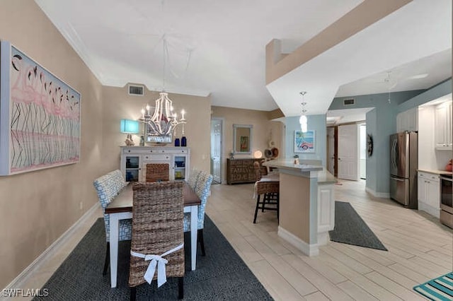 dining area featuring light hardwood / wood-style flooring and a notable chandelier