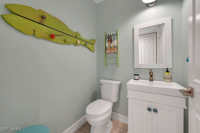 bathroom featuring vanity, tile patterned flooring, and toilet