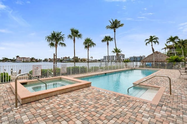 view of swimming pool with a patio and a hot tub