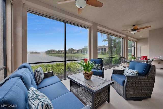 sunroom featuring a water view and ceiling fan