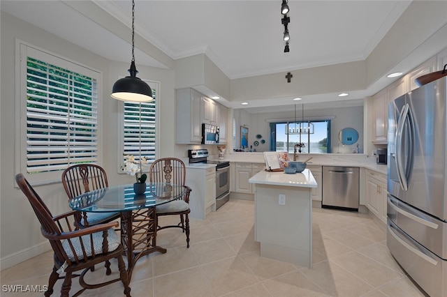 kitchen with a center island, rail lighting, hanging light fixtures, kitchen peninsula, and appliances with stainless steel finishes