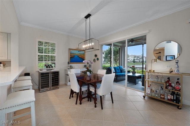 dining space with light tile patterned floors, wine cooler, and plenty of natural light