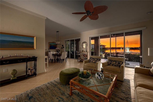 living room featuring light tile patterned floors, ceiling fan, and crown molding