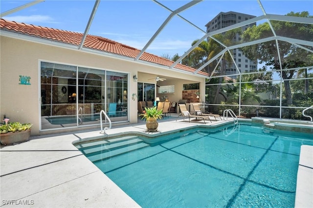 view of swimming pool featuring ceiling fan, a patio, and glass enclosure