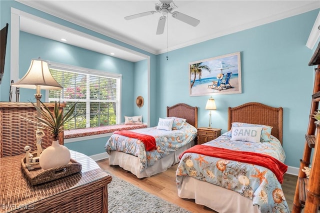 bedroom featuring ceiling fan, crown molding, and light wood-type flooring