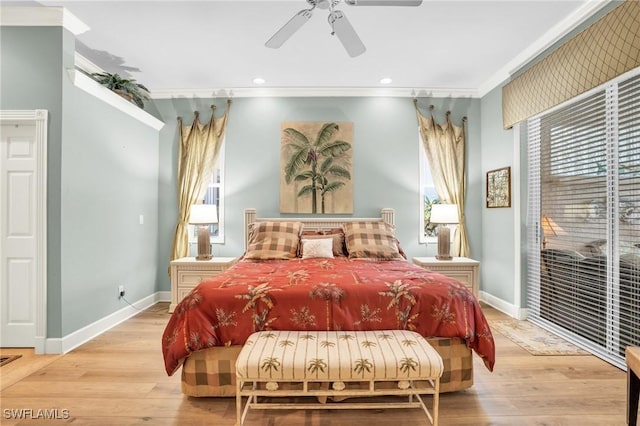 bedroom with ceiling fan, ornamental molding, and light hardwood / wood-style flooring