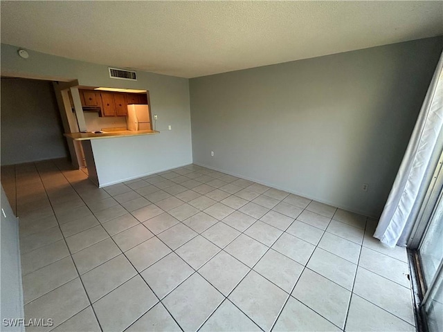 unfurnished living room featuring light tile patterned flooring