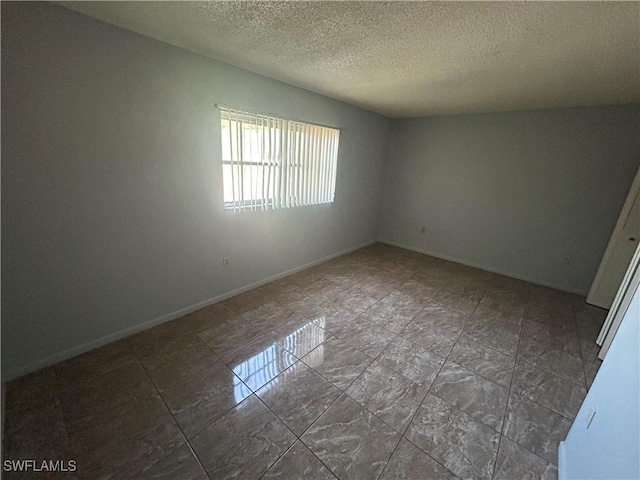 spare room featuring a textured ceiling