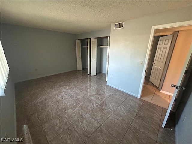 unfurnished bedroom featuring a closet and a textured ceiling