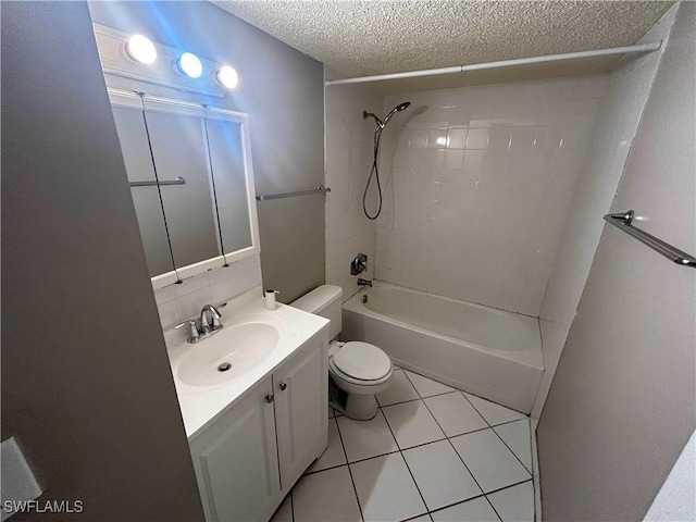 full bathroom featuring tile patterned floors, a textured ceiling, toilet, shower / washtub combination, and vanity