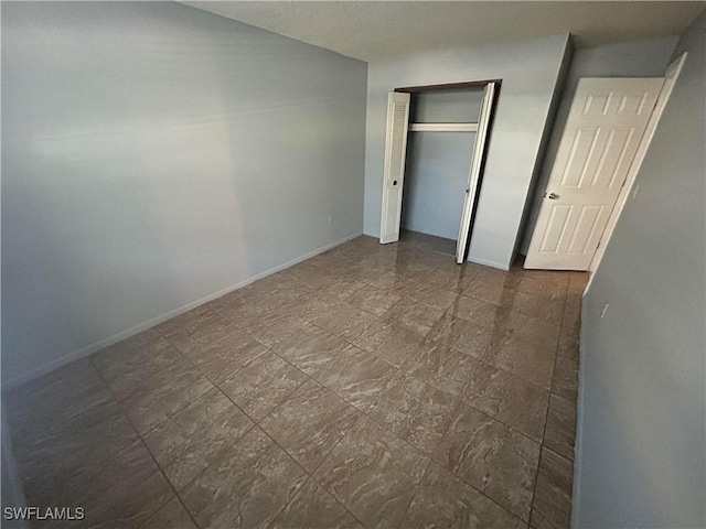 unfurnished bedroom with a closet