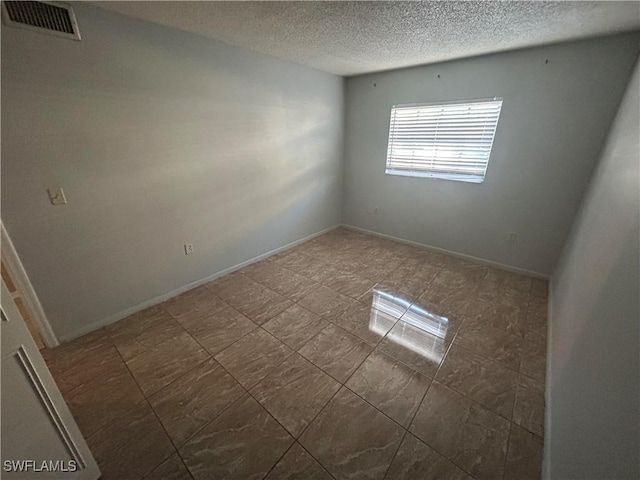 empty room featuring a textured ceiling