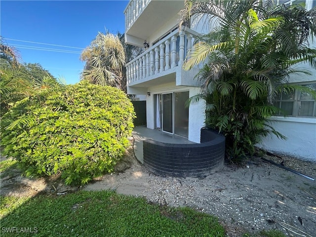 view of side of home featuring a balcony