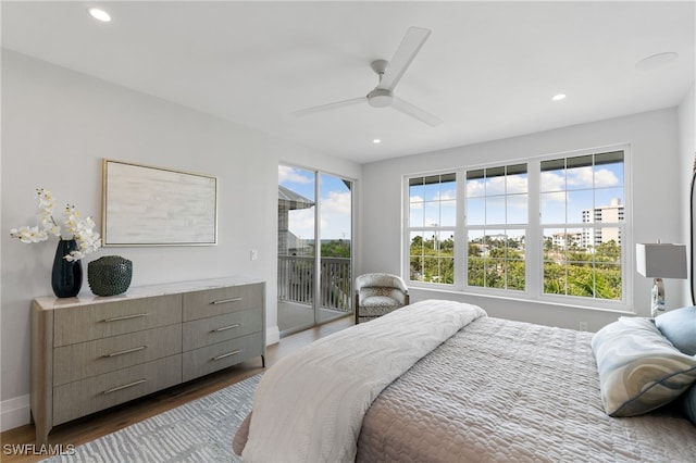 bedroom with ceiling fan, dark wood-type flooring, and access to outside