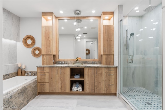 bathroom featuring vanity and independent shower and bath