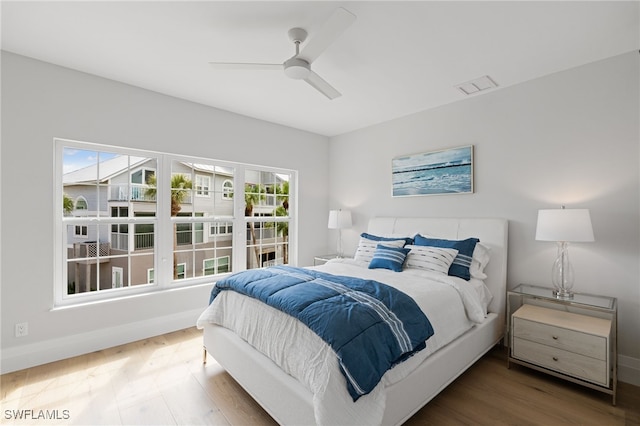 bedroom with ceiling fan and hardwood / wood-style floors