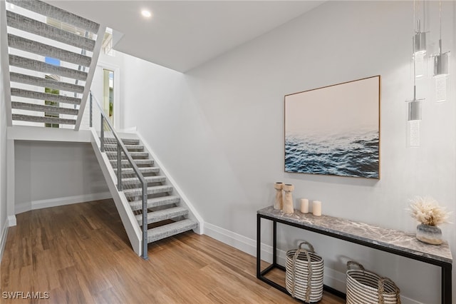 staircase featuring wood-type flooring