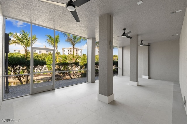 exterior space featuring ceiling fan and a healthy amount of sunlight