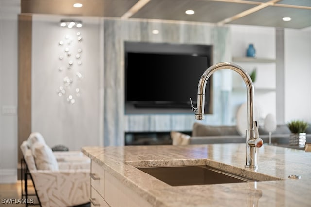 room details featuring light stone counters and sink